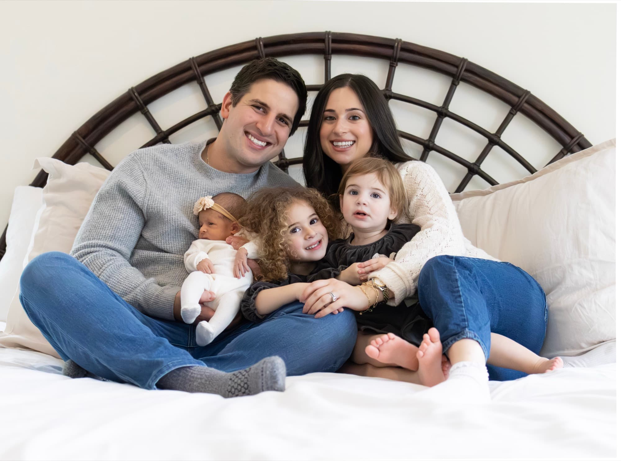 Whole family together on bed with newborn — lifestyle family photography