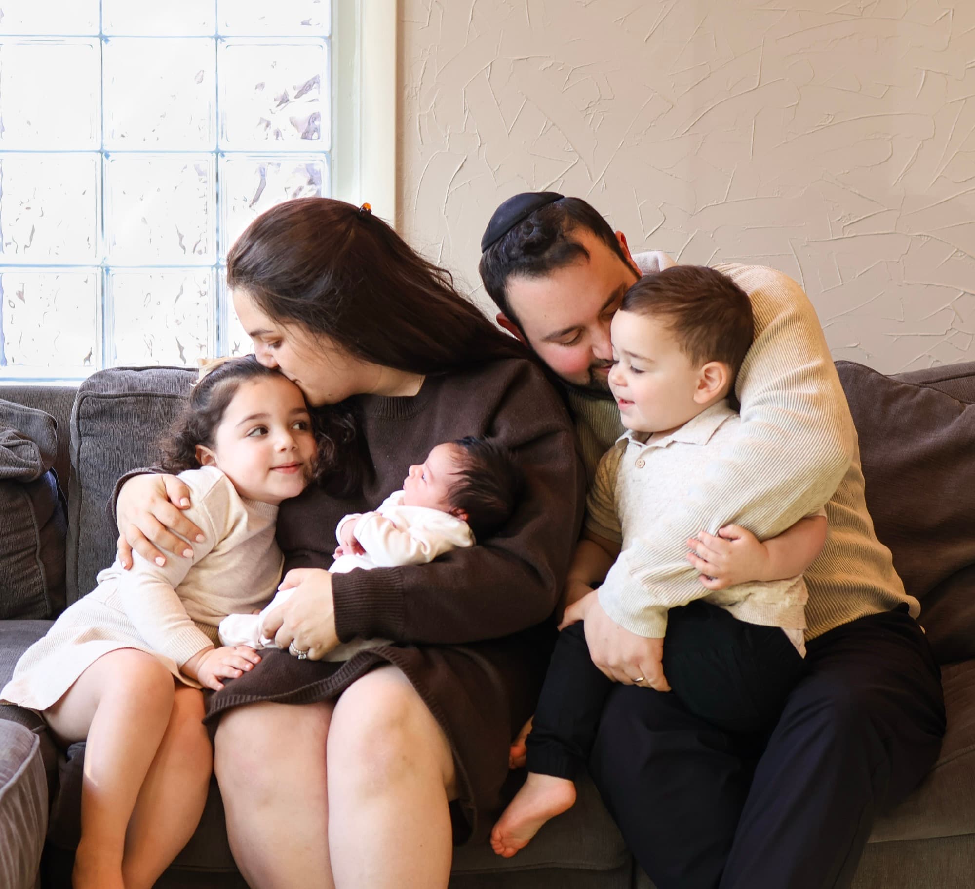 Family together on couch with newborn — lifestyle family photography
