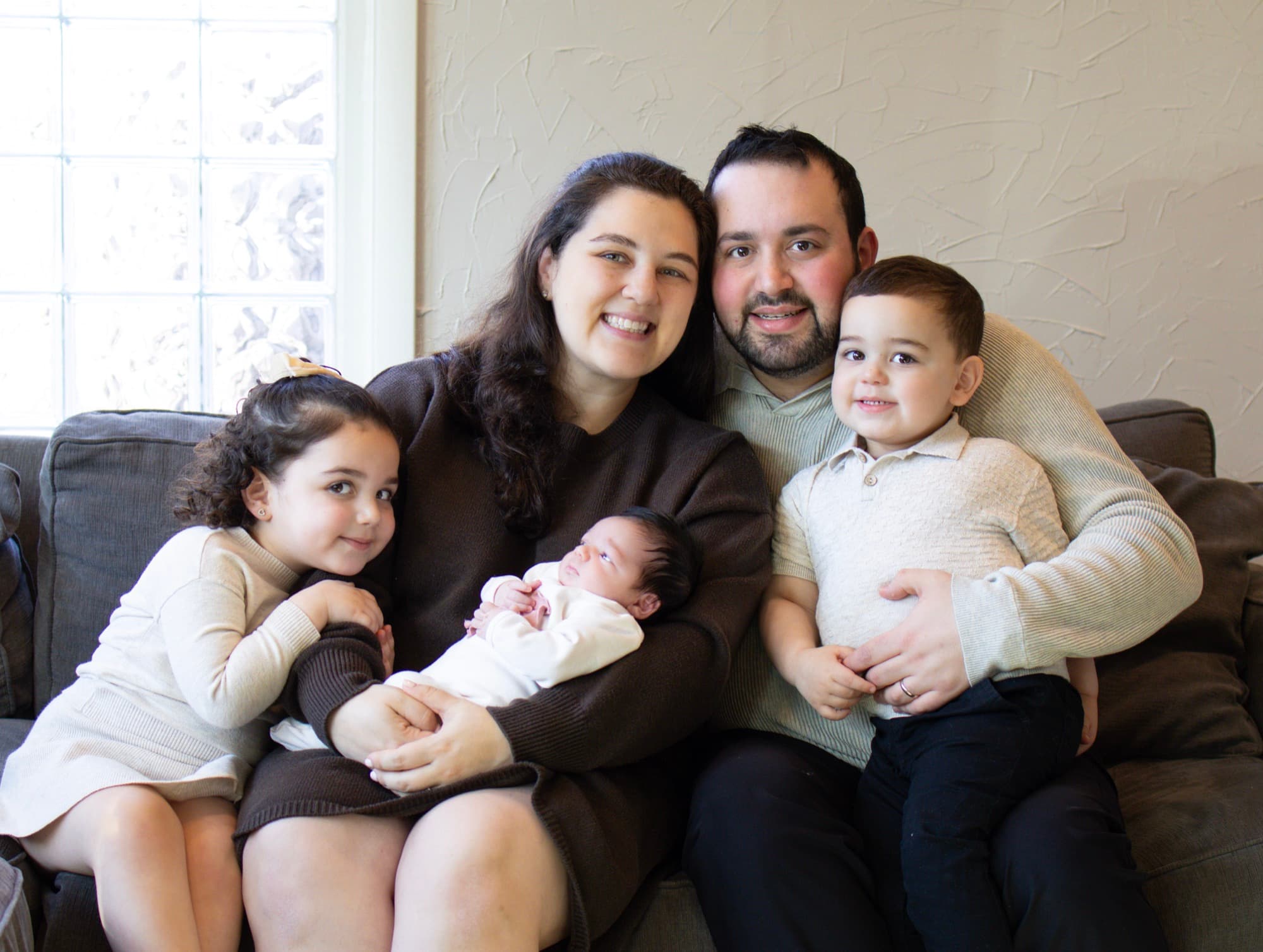 Full family portrait on couch with newborn — family photography