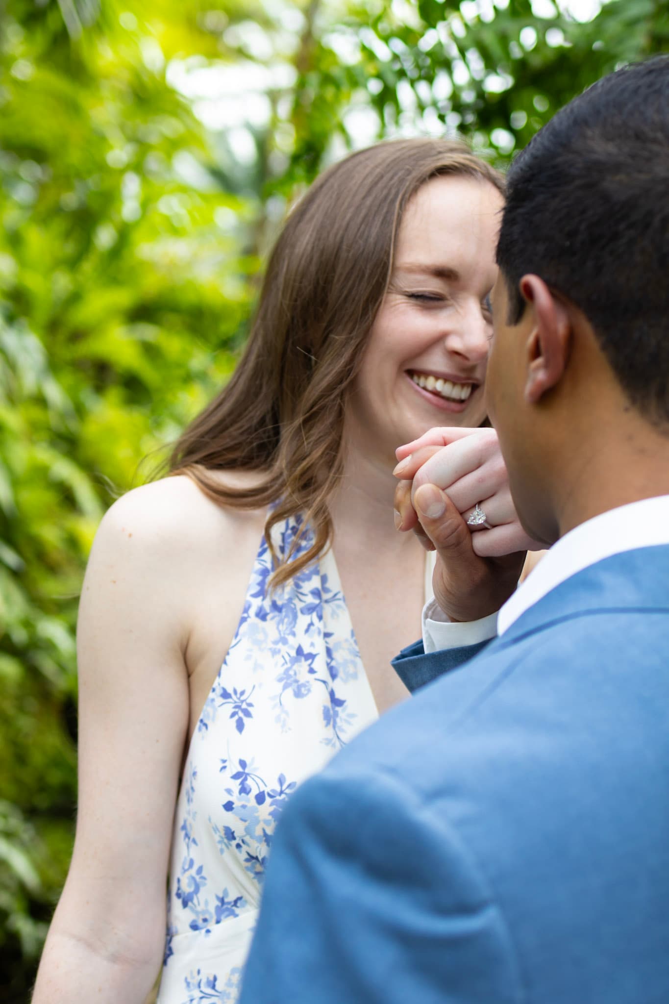 Laughing engagement portrait with the ring visible during a Garfield Park Conservatory session