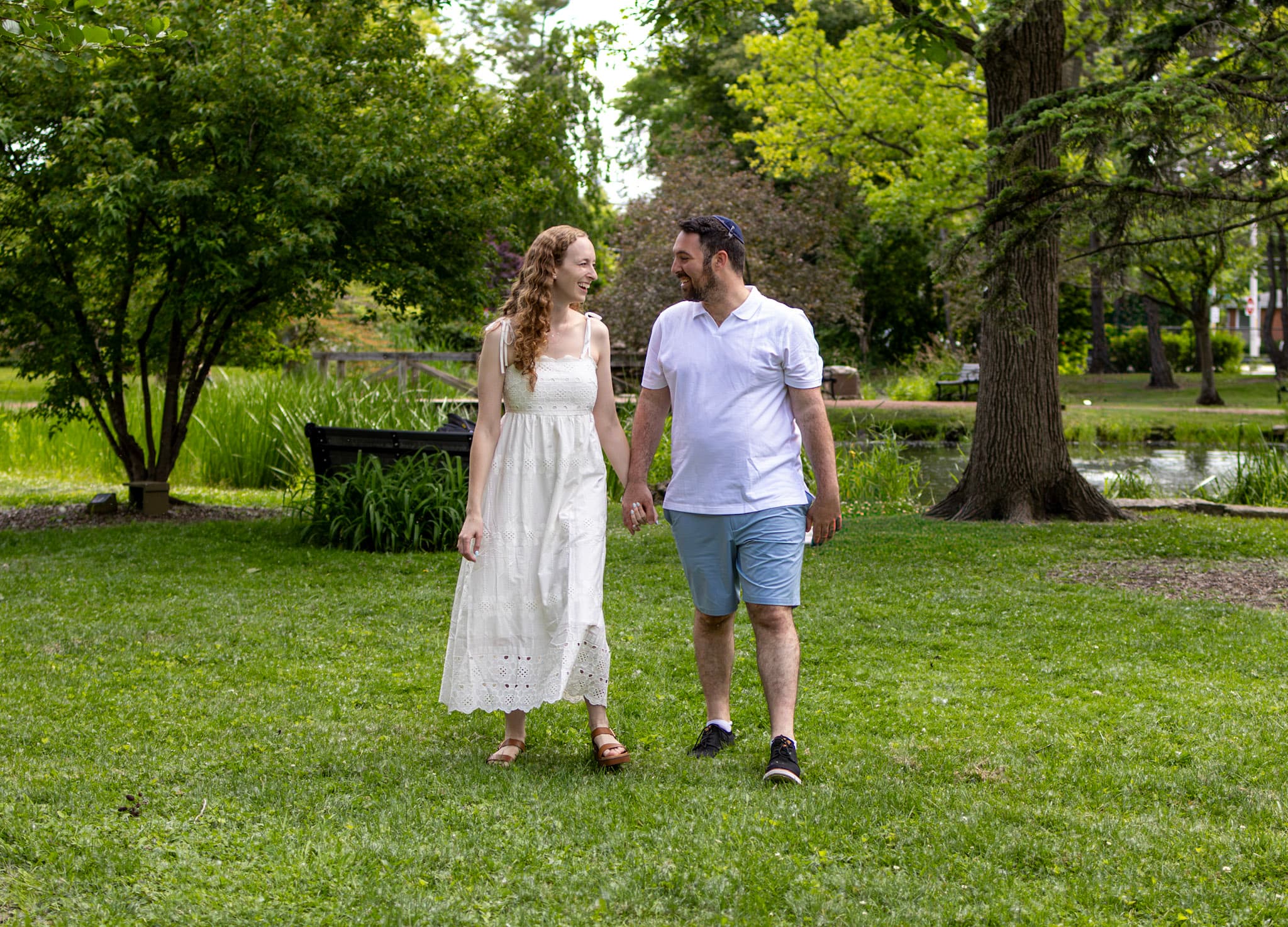 Parents walking hand in hand along a grassy path at Keay Nature Center in Wilmette