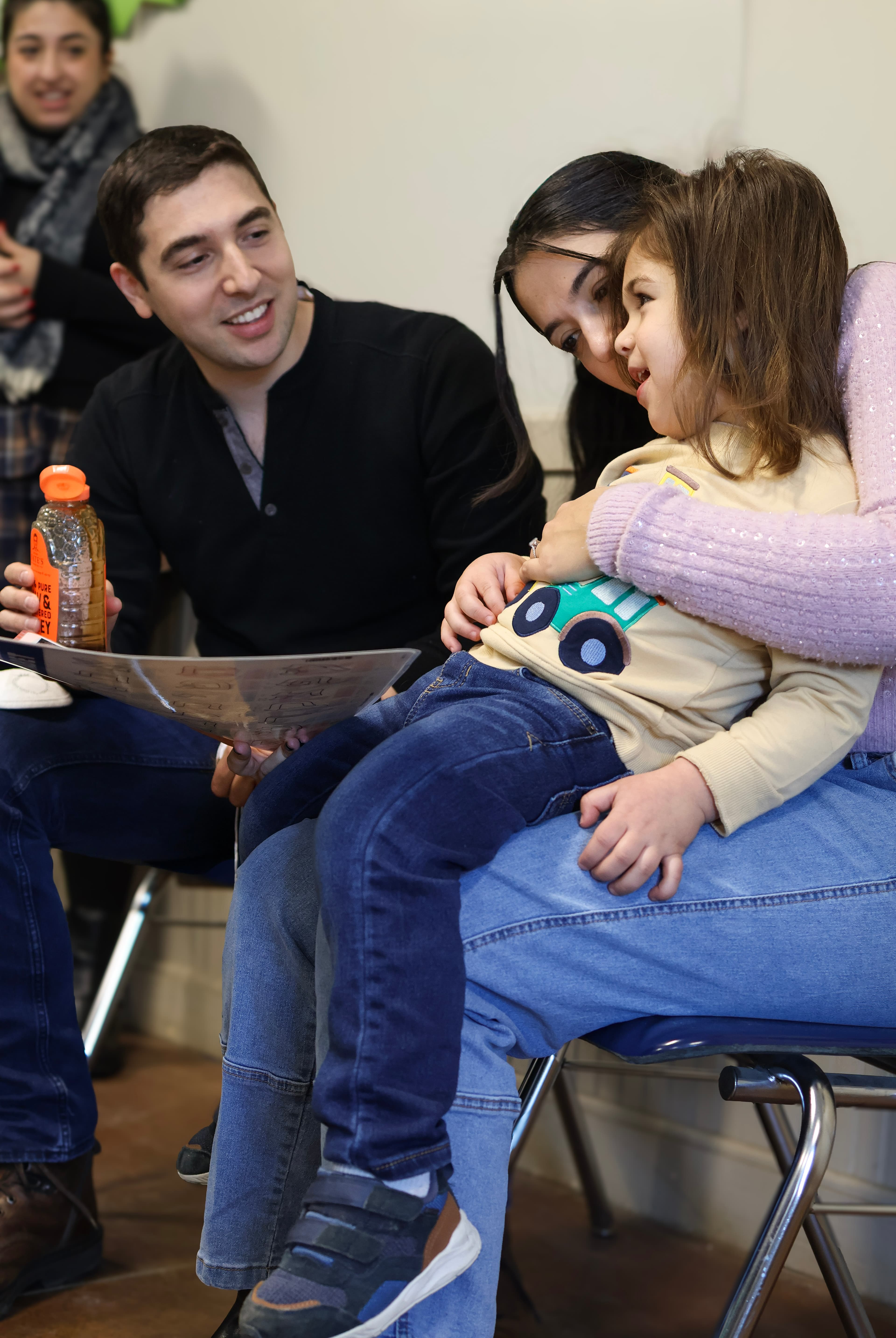 Parents and child sharing a joyful family moment — candid celebration photography