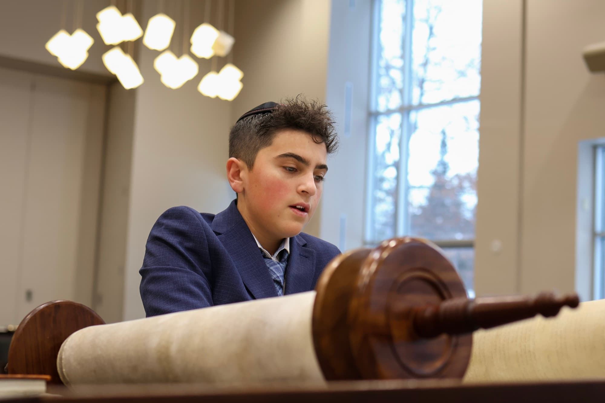 Boy reading from the Torah during Bar Mitzvah ceremony — synagogue photography