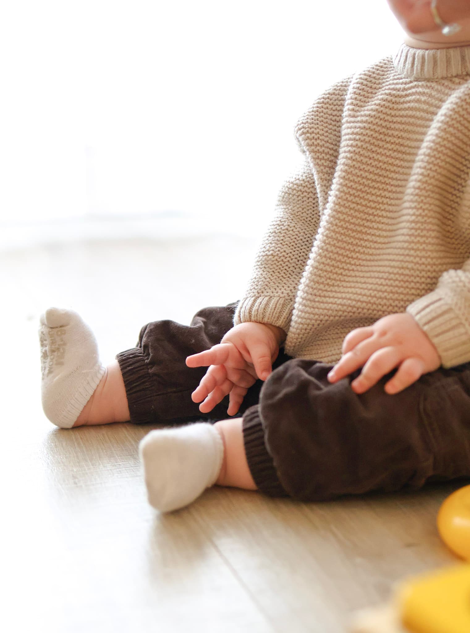 Laughing baby during a cozy at-home family photo session in West Rogers Park