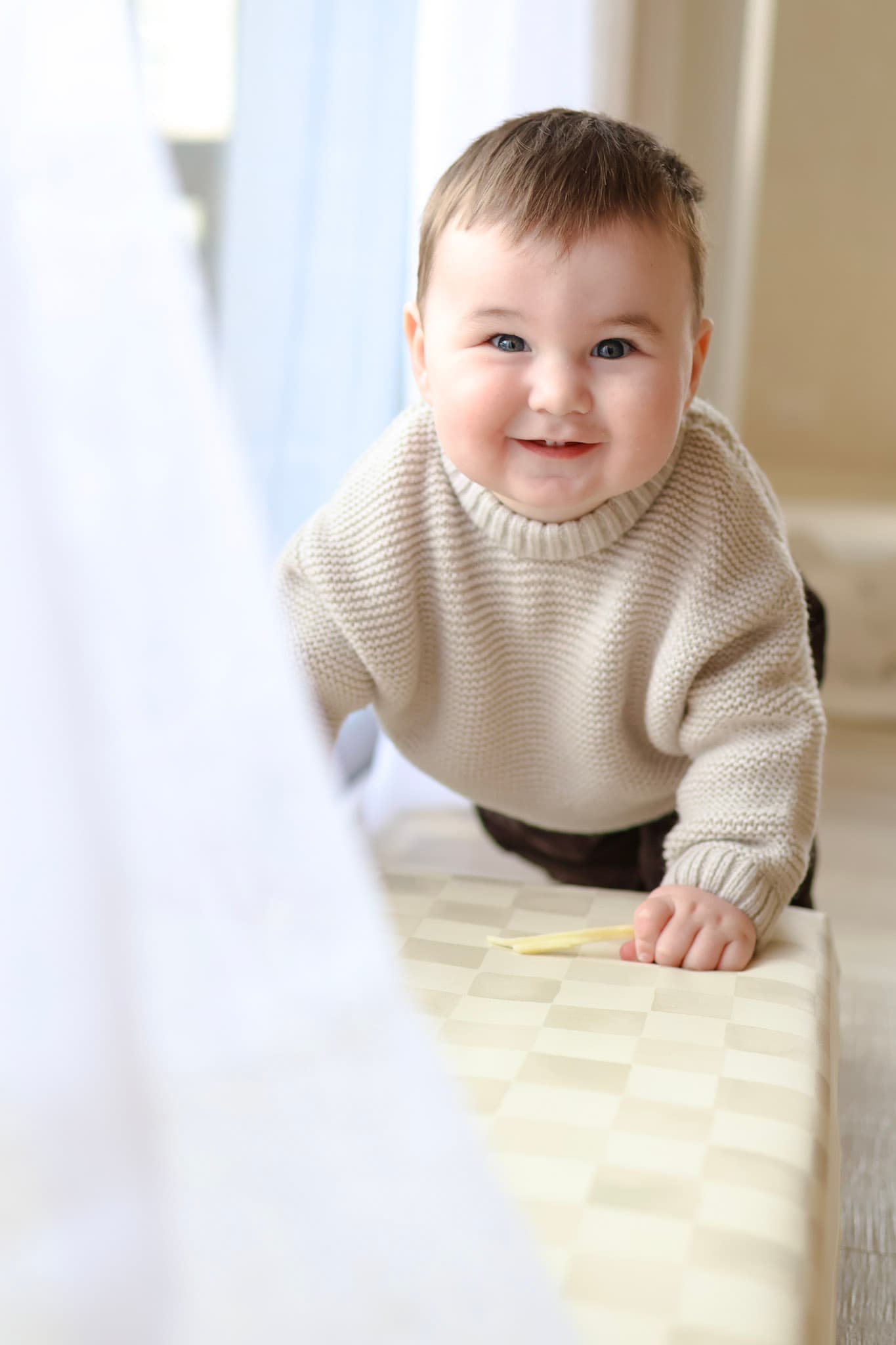 Lifestyle baby portrait from a 9 month milestone family session at home in West Rogers Park